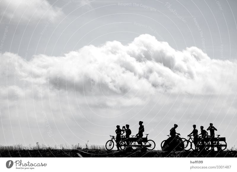 Silhouette of resting cyclists on a mountain with clouds Leisure and hobbies Mountain biking Mountain bike Trip Adventure Cycling tour Bicycle Human being