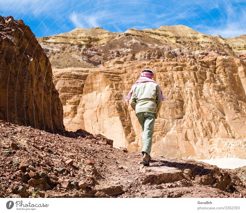 Bedouin climbs a mountain in a canyon in Egypt Dahab Exotic Vacation & Travel Tourism Summer Mountain Climbing Mountaineering Man Adults Nature Landscape Sky