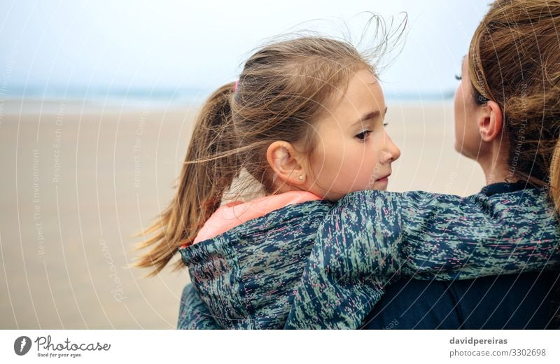 Back view of mother and daughter on the beach Lifestyle Happy Beautiful Calm Beach Ocean Child Human being Woman Adults Mother Family & Relations Sand Autumn