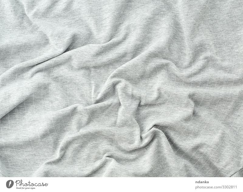 Gray fabric texture background of dark grey colored shirt. Cloth surface  and material design for empty backdrop, modern fashion clothes simple  pattern. Blank apparel canvas and copy space Stock Photo