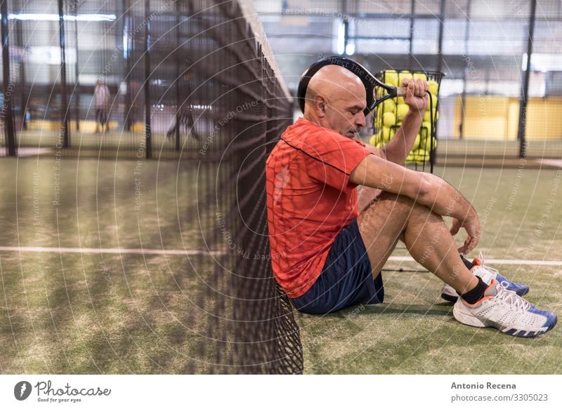 senior man playing paddle tennis at indoors pitch, he is tired Playing Sports Man Adults Bald or shaved head Beard Old Competition padel Court building match