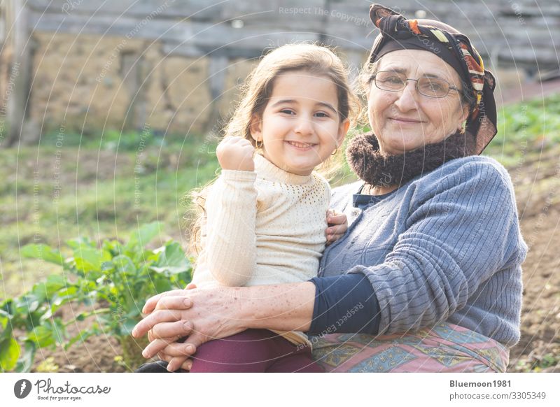 Portrait of a happy little girl with her senior grandmother at garden Lifestyle Style Playing Garden Mother's Day Child Human being Girl Woman Adults