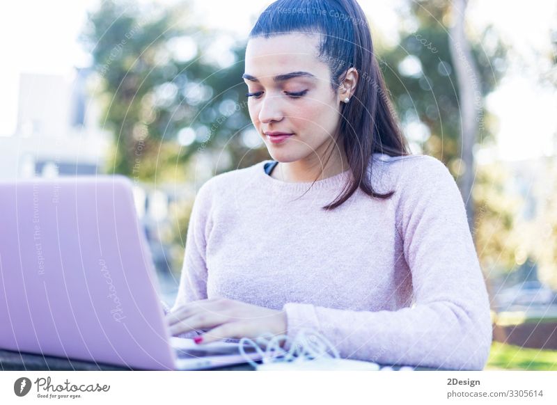 Young beautiful woman sitting outdoors while working with laptop Lifestyle Happy Beautiful Academic studies Work and employment Business Computer Notebook