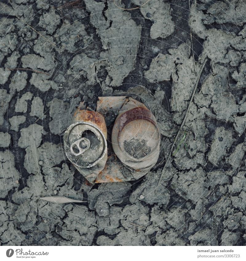 old rusty can on the dry puddle, global warming broken metallic object isolated alone abandoned still life garbage Climate change ground land sand