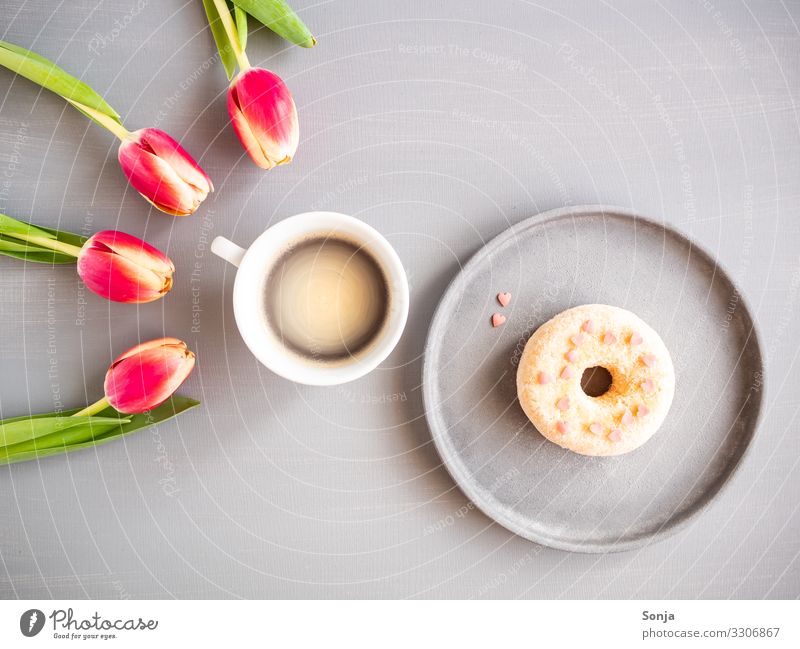 Pink tulips with a cup of coffee and a donat Food Dough Baked goods Nutrition Breakfast To have a coffee Beverage Hot drink Coffee Plate Cup Lifestyle Flower
