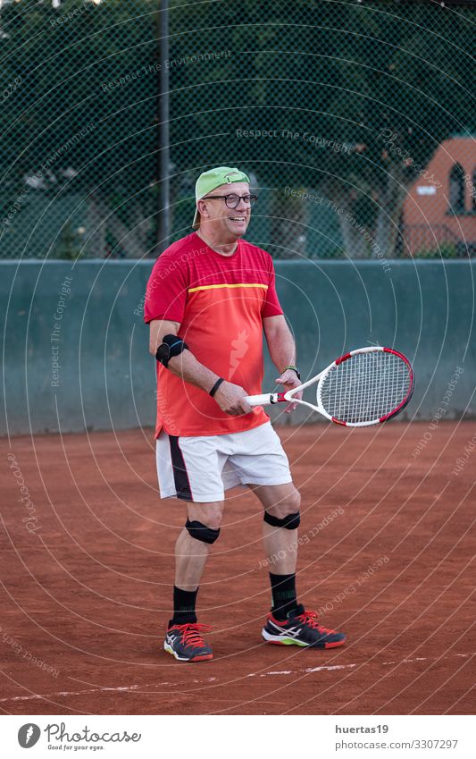 A middle-aged man plays tennis Lifestyle Playing Sports Ball sports Human being Masculine Man Adults 1 45 - 60 years Old Competition Racket ball Tennis