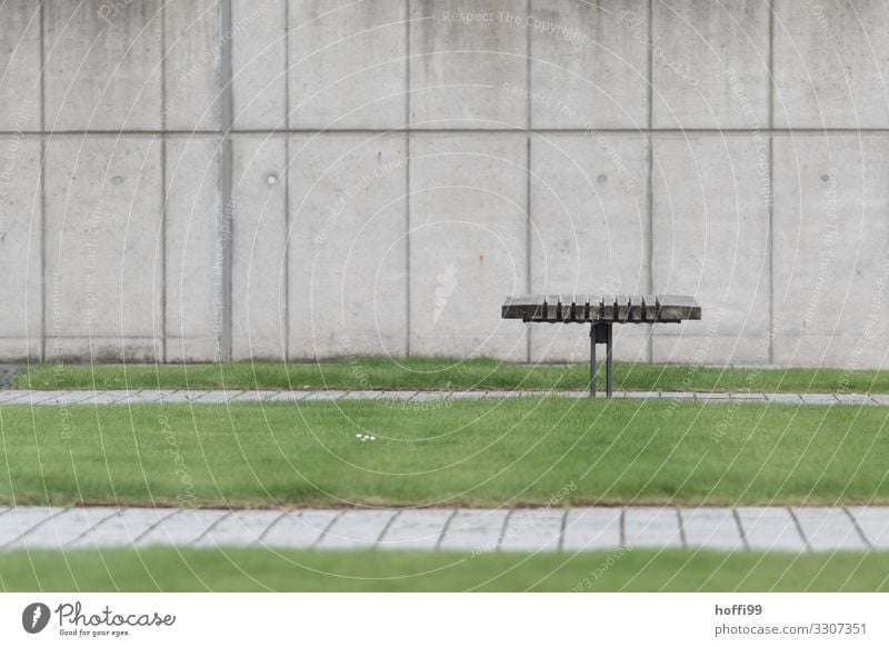 minimalistic view of a bench with lawn in front of a concrete wall Grass Lawn Building Wall (barrier) Wall (building) Bench Park bench Concrete Wood Line Wait