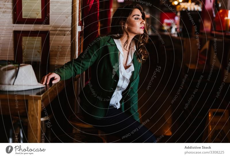 Charming lady in classy clothing in cafe woman stylish outfit fashionable trendy young casual female model wear smile enjoy clothes elegant charming accessories