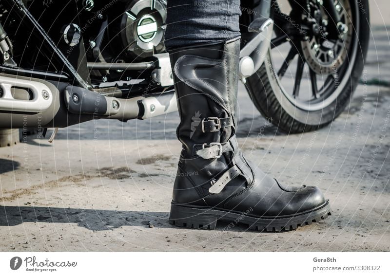 biker leg in a boot against the backdrop of a motorcycle Human being Legs Feet 1 Transport Street Vehicle Motorcycle Leather Footwear Gray Black Motorcycling