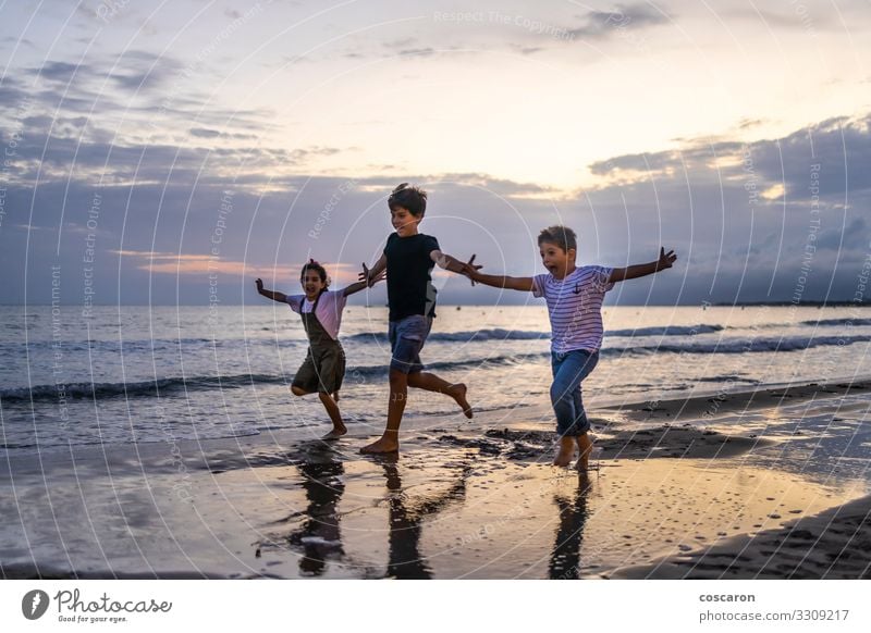 Three kids running on the beach at sunset Lifestyle Joy Happy Relaxation Leisure and hobbies Playing Vacation & Travel Adventure Freedom Summer Sun Beach Ocean