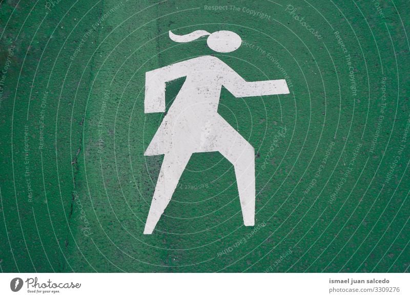 pedestrian woman road sign on the green road in Bilbao city Spain walker traffic signal warning street symbol way caution roadsign advice safety outdoors bilbao