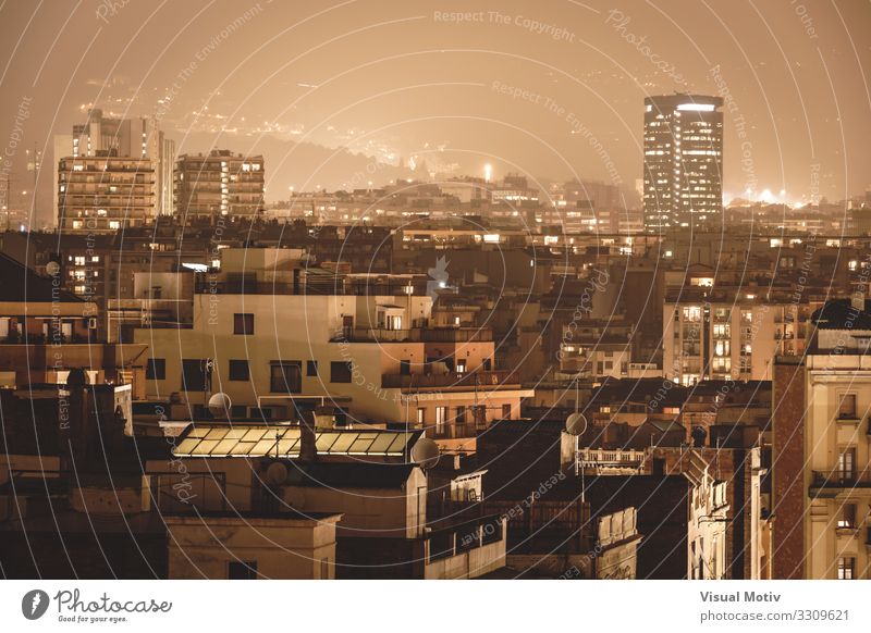 Buildings under the city lights surrounded by a foggy atmosphere Town Capital city Port City Skyline Populated Manmade structures Architecture Window Facade