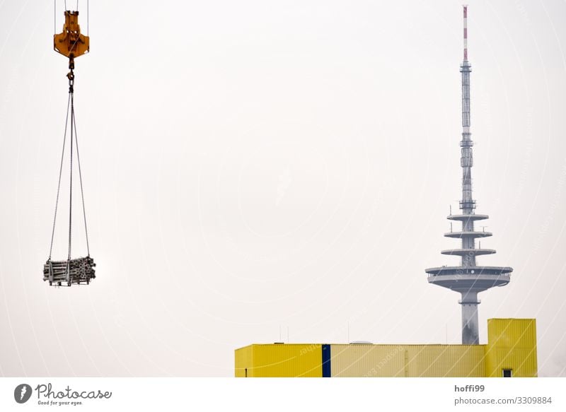 Television tower with warehouse and crane transporting a load of steel pipes Crane Industry Tower Building Transmitting station Facade Antenna Esthetic Gigantic