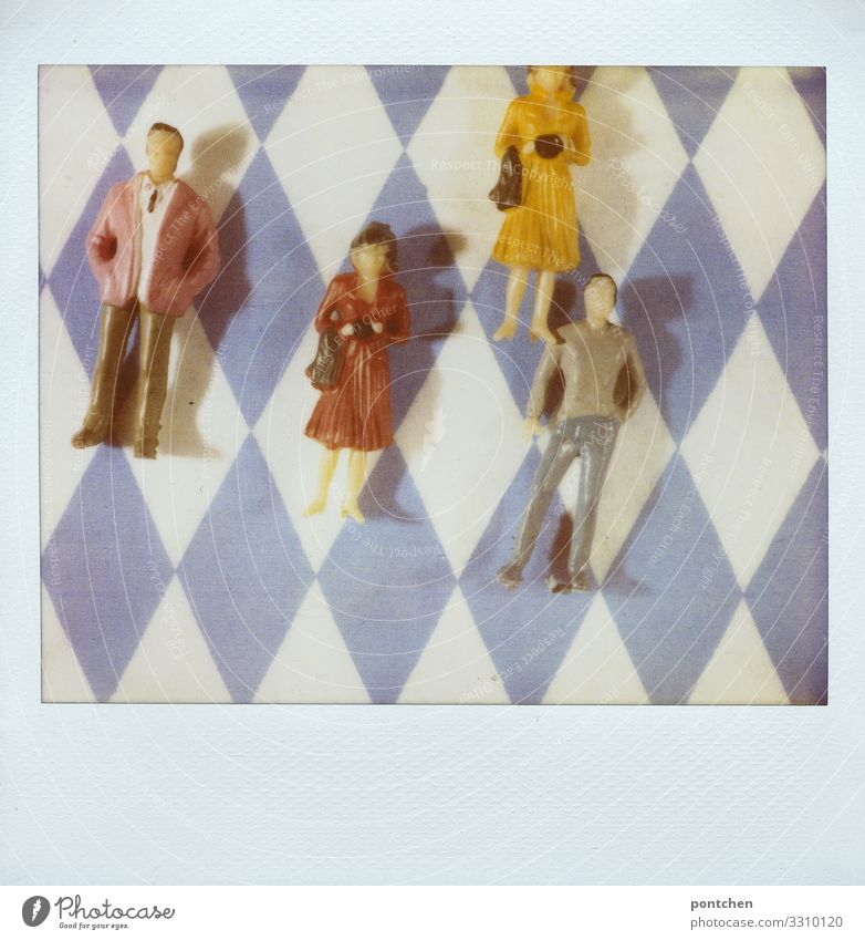 Polaroid shows toy people female and male lying on bavarian rhombus pattern Human being Masculine Feminine Woman Adults Man Couple Partner 4 Group 18 - 30 years
