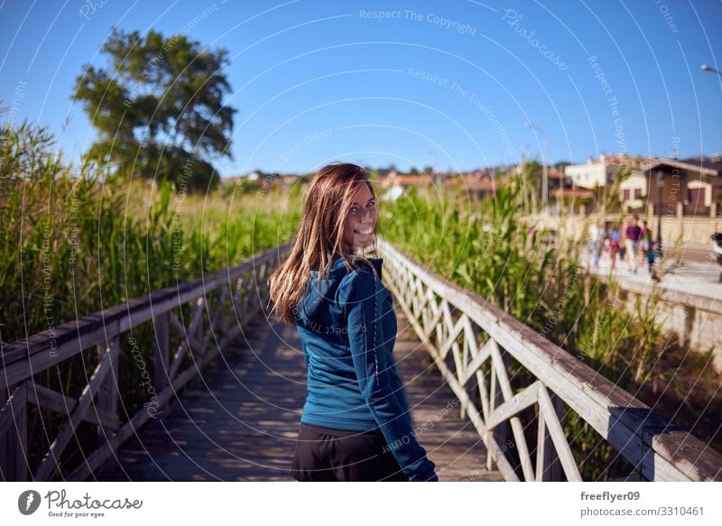 Young woman walking by a wood footbridge Lifestyle Relaxation Hiking Vacation & Travel Tourism Adventure Freedom Summer Youth (Young adults) Woman Adults 1