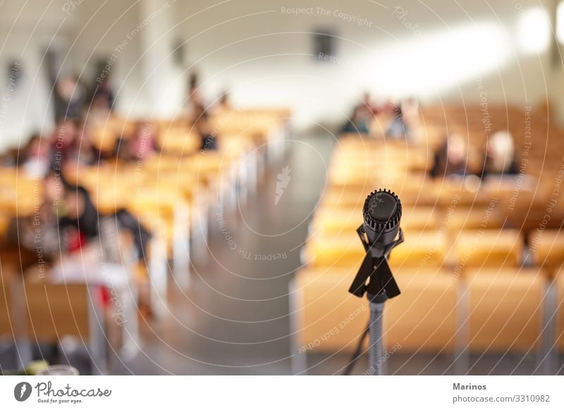 Closeup view of microphone in university teaching room. Table Audience Adult Education Business Meeting Media Church Performance Conference Microphone Public