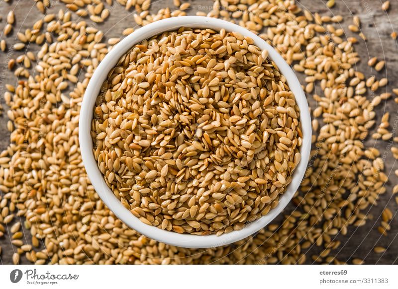 Golden flax seeds in white bowl on wooden table. Flax Seed Seeds Food Healthy Eating Dish Food photograph Diet Ingredients Grain Exceptional Good Agriculture