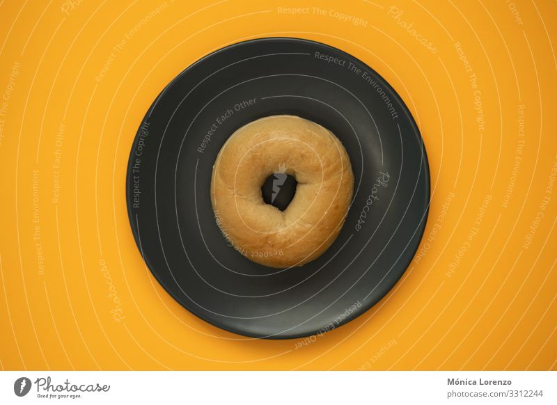 Bagel isolated on a grey plate with orange background. Top view. Dough Baked goods Bread Eating Breakfast Diet Stove & Oven Wood Fresh White Wheat Flour brunch