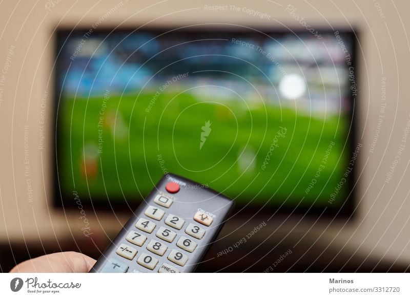 TV remote control and an open television as background. Entertainment Sports Computer Screen Technology Internet Man Adults Hand Media Television Observe Smart