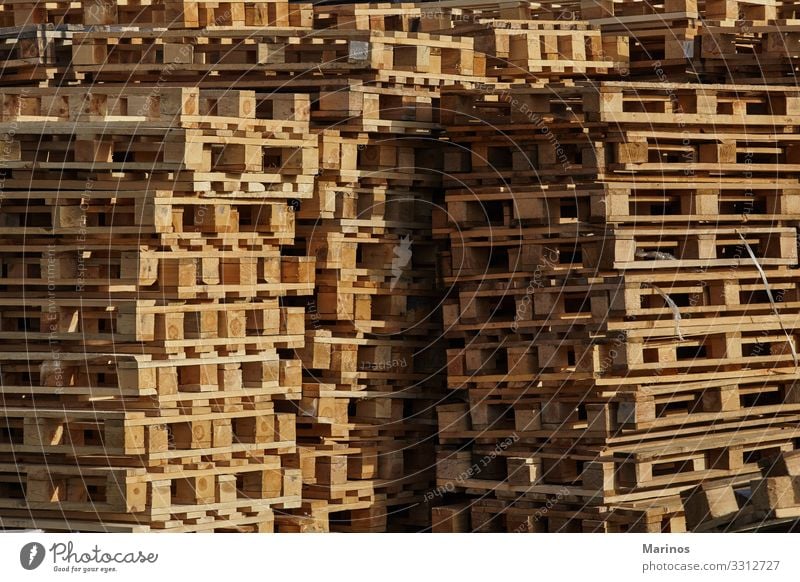 Wooden spools, cable reels, stacked up for storage in an industrial park -  a Royalty Free Stock Photo from Photocase