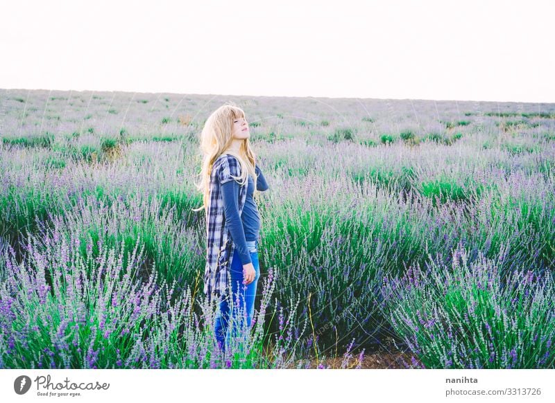 Young blonde woman alone in a lavender field young nature life garden gardening parfum spring springtime flowers lovely freedom candid real real woman summer