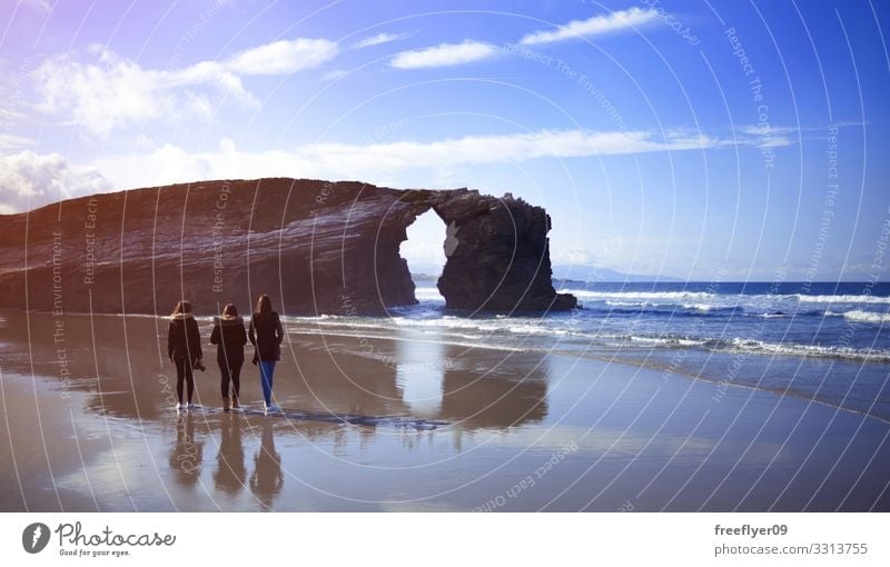 Three young women walking on Cathedrals Beach in Galicia three beach cathedrals ribadeo galicia tourism spain hiking ocean coast natural atlantic scenic tide