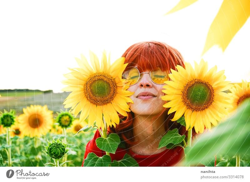 Lovely redhead woman enjoying the day in a field o sunflowers happiness spring young freedom life summer holidays fun funny candid real real people lifestyle