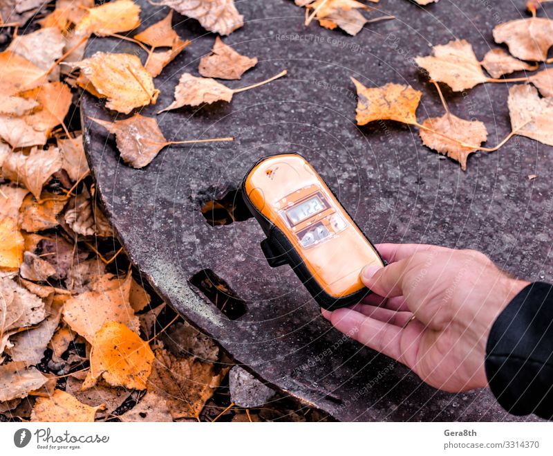 dosimeter device in hand near an radioactive object in Chernobyl Vacation & Travel Tourism Trip Man Adults Hand Nature Autumn Leaf Street Metal Old Threat