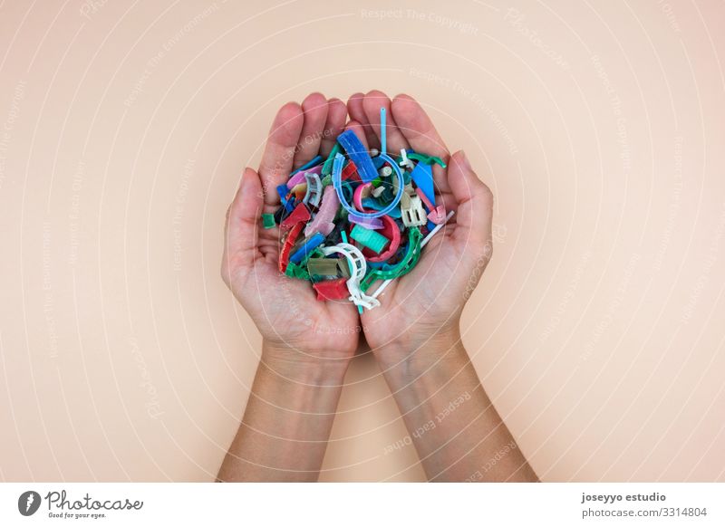 Hands full of micro plastics collected on the beach. Beach Ocean activists Awareness Cleaning Close-up Coast damage Destruction Dirty Earth Ecological