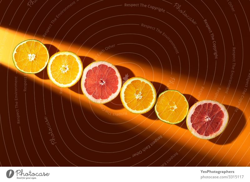 Sliced citrus fruits in sunlight. Oranges and grapefruits - a Royalty Free  Stock Photo from Photocase