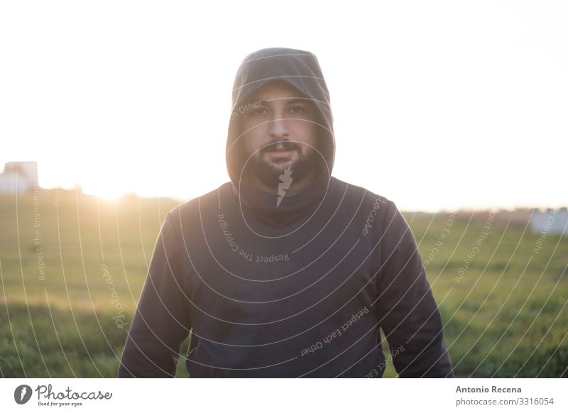 Bearded runner resting after training outdoors Lifestyle Sports Human being Man Adults Fitness Stand Serene Mysterious Runner sportsman hood Arabia