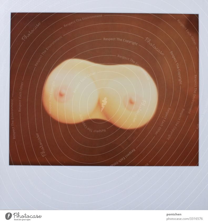 Polaroid shows plastic breasts on wooden table Feminine Breasts Esthetic Eroticism Silicone Plastic surgery Nipple Skin Naked Deserted Copy Space bottom Body