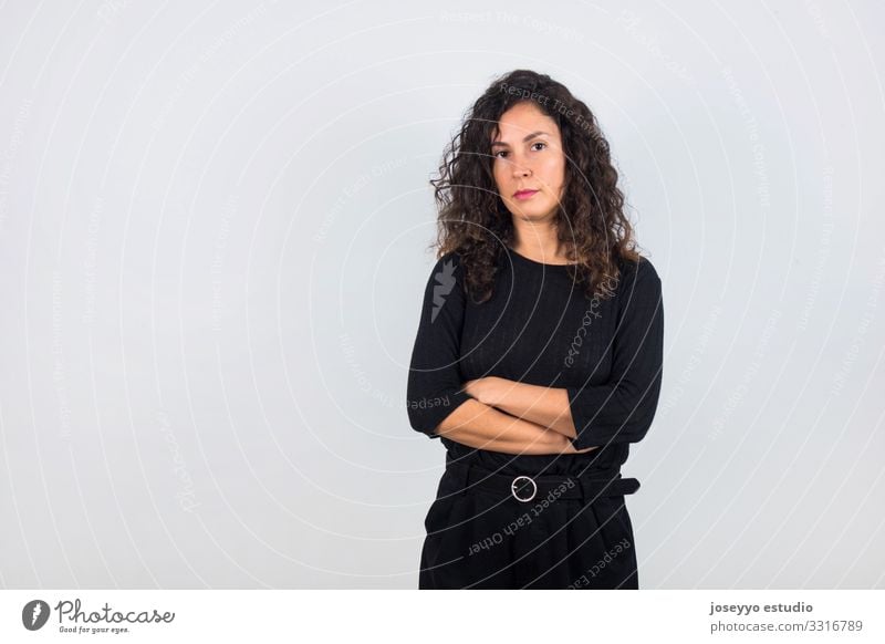 Brunette woman with black shirt and arms crossed. 30 - 45 years attitude Beauty Photography Brown Casual clothes Curly hair dressed in black Elegant empowerment