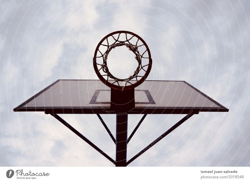 basketball hoop sports equipment on the street, street basket in Bilbao city Spain sky blue silhouette circle chain metallic net play playing playful old park