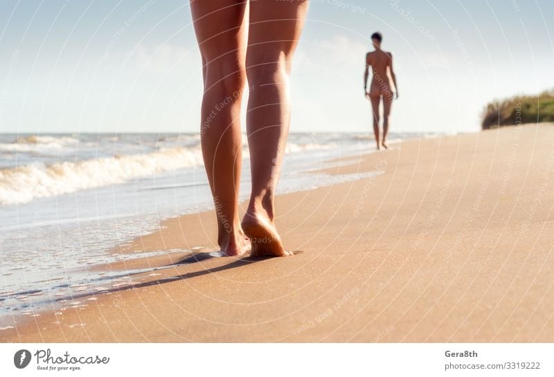 nude young girls walk on the beach in the waves of the surf Body Vacation & Travel Freedom Summer Beach Ocean Waves Woman Adults Couple Feet Nature Landscape