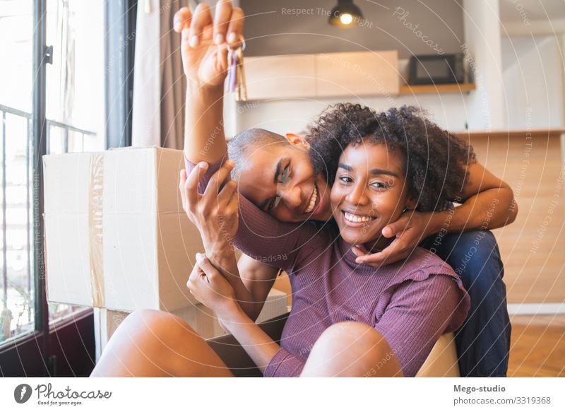 Latin couple having fun with cardboard boxes in new house. Lifestyle Joy Happy Beautiful Relaxation Flat (apartment) House (Residential Structure)