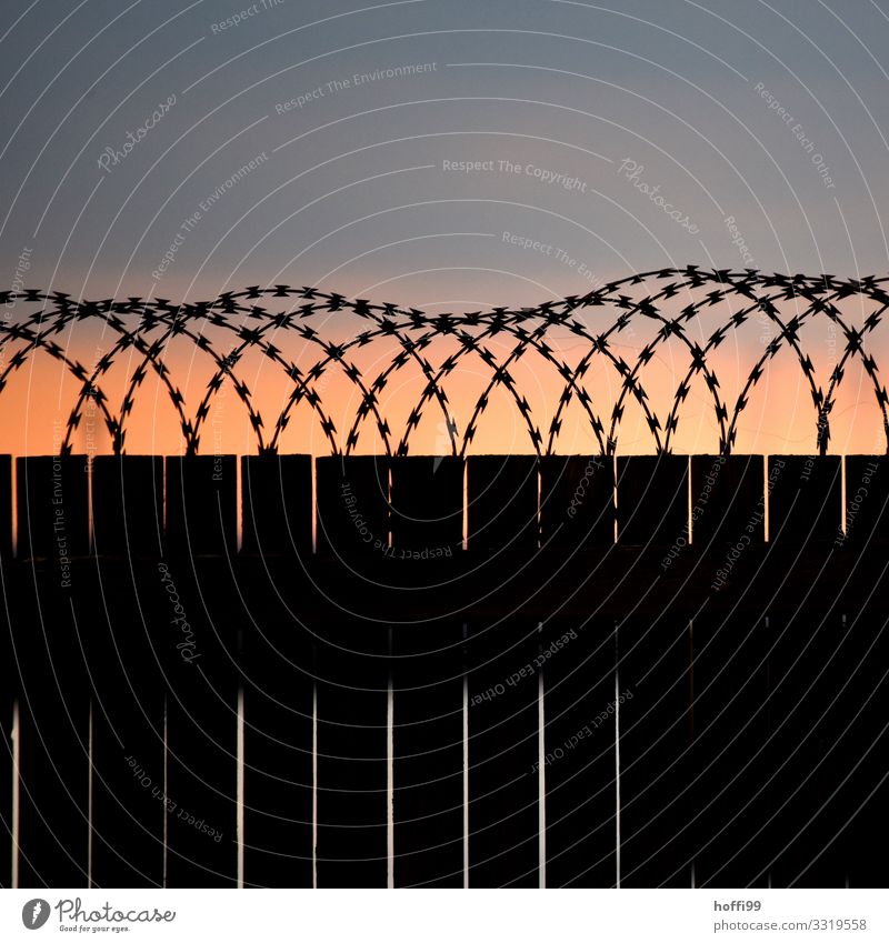 Barbed wire on wooden bridle in sunset with grey sky Storm clouds Sunrise Sunset Weather Gale Fence Wooden fence Barbed wire fence Death Mistrust Animosity