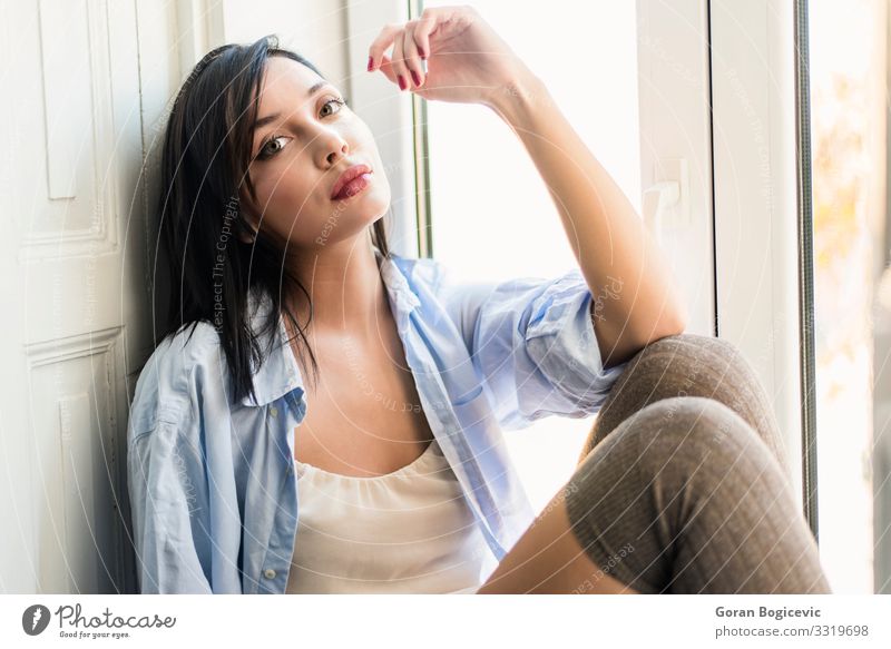 Young woman relaxing by the window Lifestyle Beautiful Relaxation Leisure and hobbies Human being Feminine Youth (Young adults) Woman Adults 1 18 - 30 years Joy