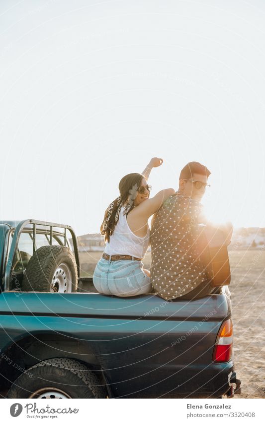 Young travelers having fun with the guitar on top of car Lifestyle Happy Beautiful Vacation & Travel Tourism Summer Sun Woman Adults Man Couple Guitar Landscape