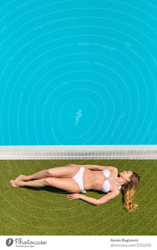 Young woman relaxing by the swimming pool Relaxation Calm Swimming pool Leisure and hobbies Summer Sun Human being Youth (Young adults) Woman Adults 1
