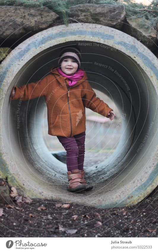 Child in tunnel playground Feminine Toddler 1 Human being 3 - 8 years Infancy Winter Park Jacket wollwalk Wool jacket Scarf Cap Movement Smiling Playing Romp