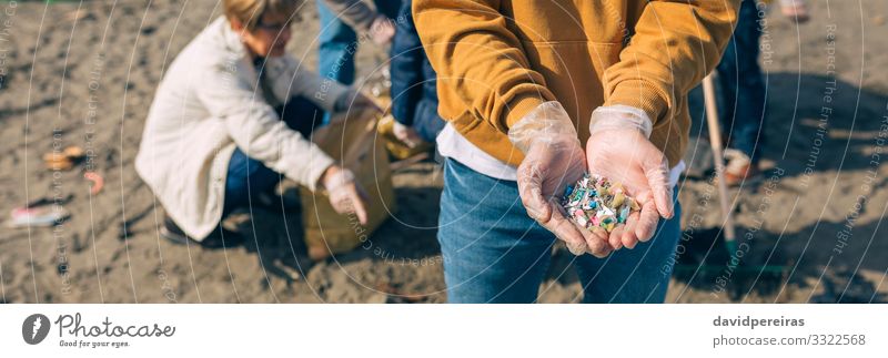 Hands with microplastics on the beach Beach Internet Human being Man Adults Group Environment Sand Plastic Old Dangerous Teamwork Environmental pollution