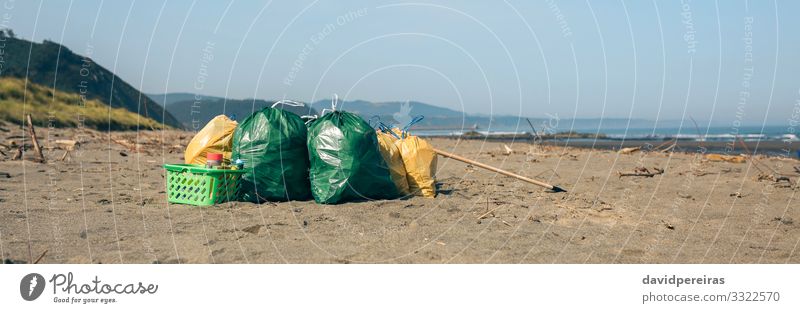 Garbage bags and utensils on the beach Beach Internet Environment Nature Landscape Sand Coast Clean Disaster Teamwork garbage bags after Trash collected