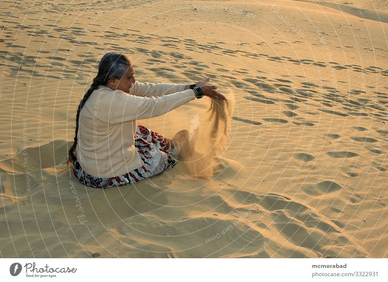 Playful Lady at Sand Dunes Joy Playing Vacation & Travel Woman Adults Places Drop To enjoy Yellow Gold Colour Horizontal Asia India Rajasthan Jaisalmer