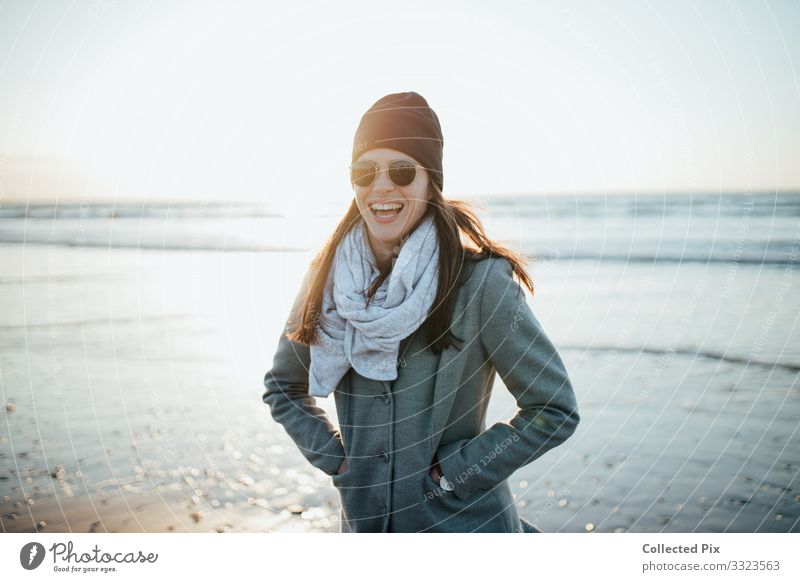 Happy woman on beach in winters clothes Feminine Young woman Youth (Young adults) Sister Body 1 Human being 18 - 30 years Adults Environment Nature Landscape
