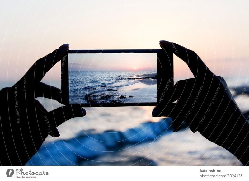 Girl is taking a sunset photo on the mobile phone Vacation & Travel Summer Beach Ocean Cellphone PDA Technology Woman Adults Hand Environment Nature Landscape