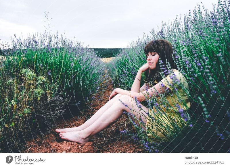 Young brunette woman sitting surrounded by lavender Lifestyle Beautiful Relaxation Calm Freedom Summer Human being Feminine Young woman Youth (Young adults)