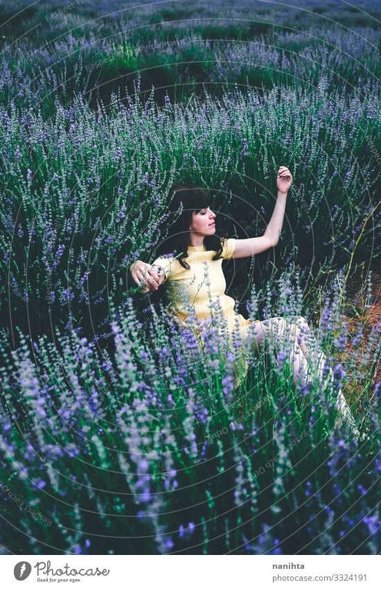 Young brunette woman sitting surrounded by lavender Lifestyle Beautiful Relaxation Calm Freedom Summer Human being Feminine Young woman Youth (Young adults)