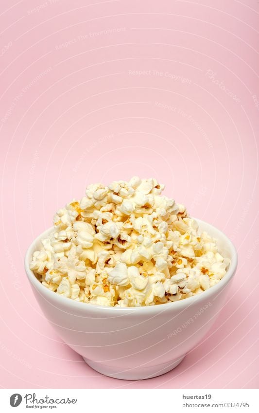 Popcorn on colored backgrounds Food Fast food Bowl Entertainment Cinema Fresh Delicious Pink White Colour Snack Salty movie Classic full pop Tasty isolated