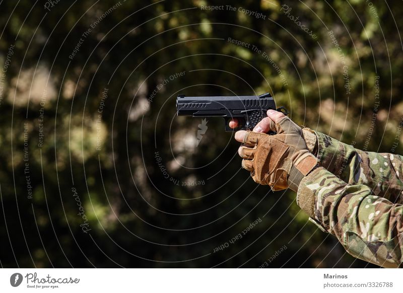 Soldier's hand points with a gun. Military concept. Man Adults War military army training Virtual Weapon background Conceptual design Combat shooting Hold fight